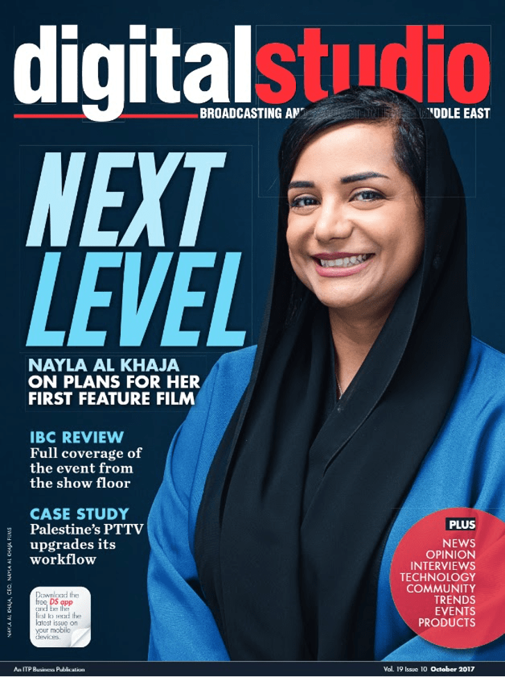 Portrait of Nayla Al Kahaja on the cover of Digital Studio magazine. Al Kahaja wears blue and black and smiles for the camera.