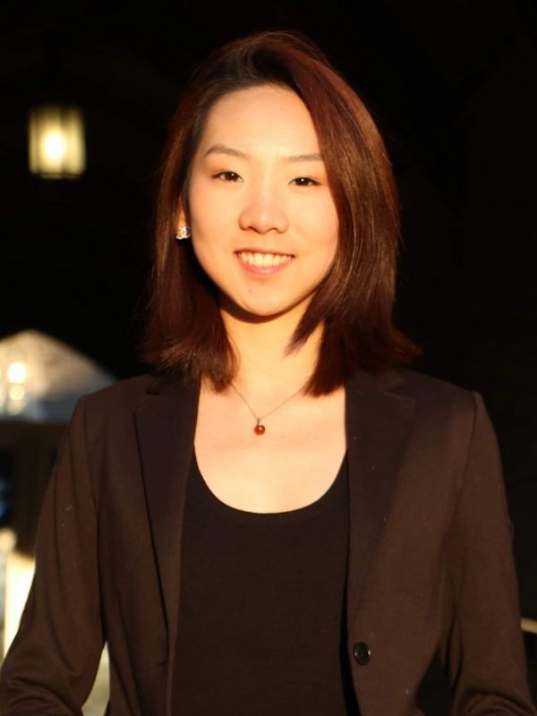 Young Asian woman with reddish cropped hair and smiling