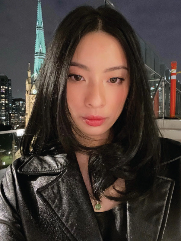 Fashion Communication student Ellen Tracy Wong takes a selfie. She has black hair and natural makeup