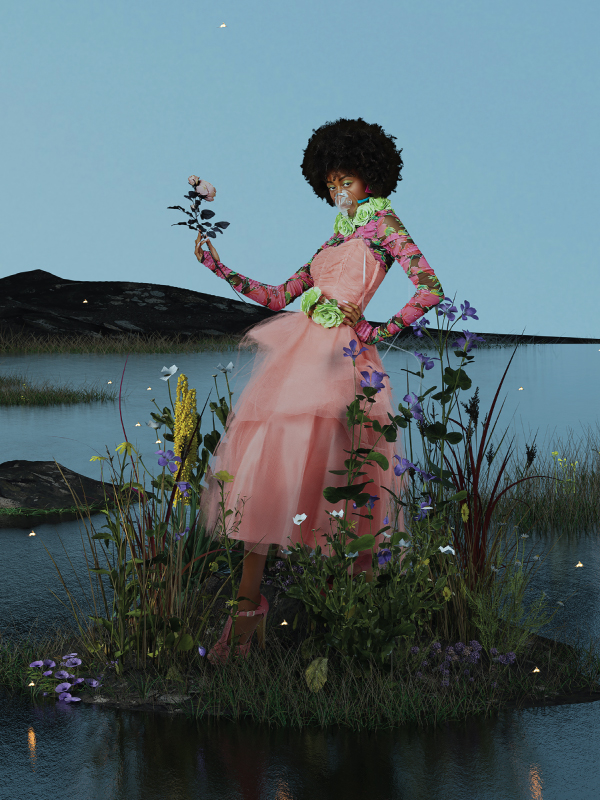 A woman wears a pink tulle dress and stands on a small island of grass on a flower that sits on a pond at night
