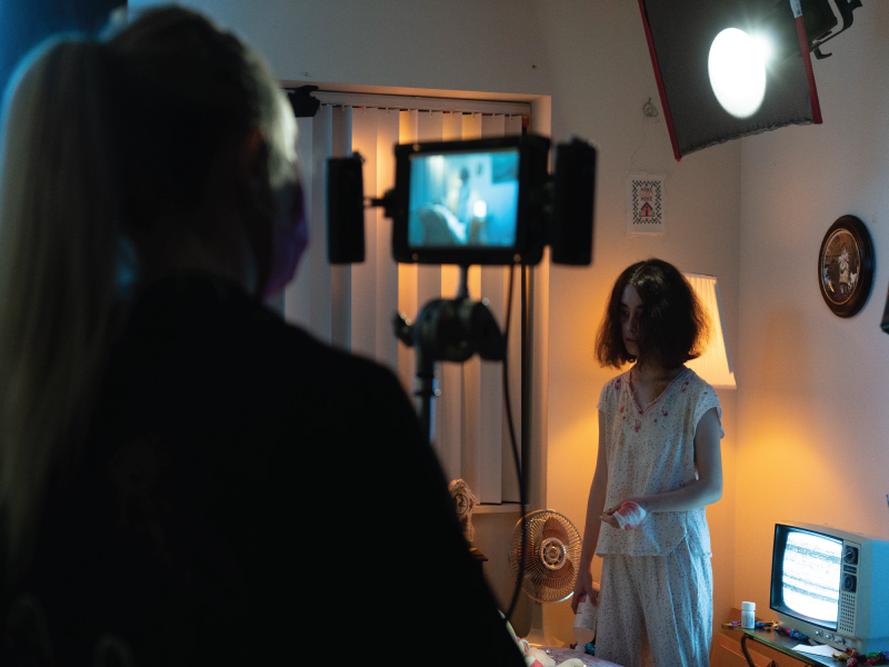Behind the scenes of the film ‘Cordelia!’ The image features a woman standing and a video camera on her