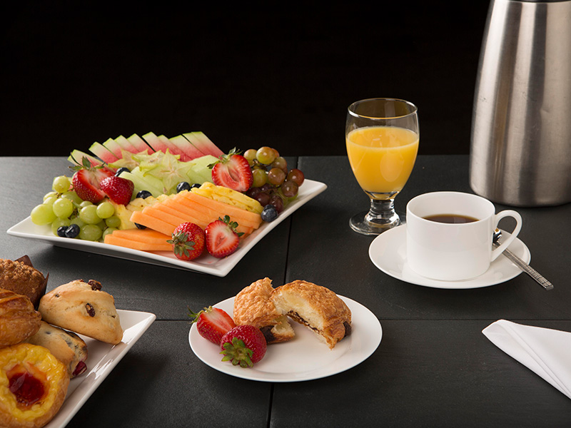 TMU Eats catering menu breakfast items with juice, pastries, fresh fruit.