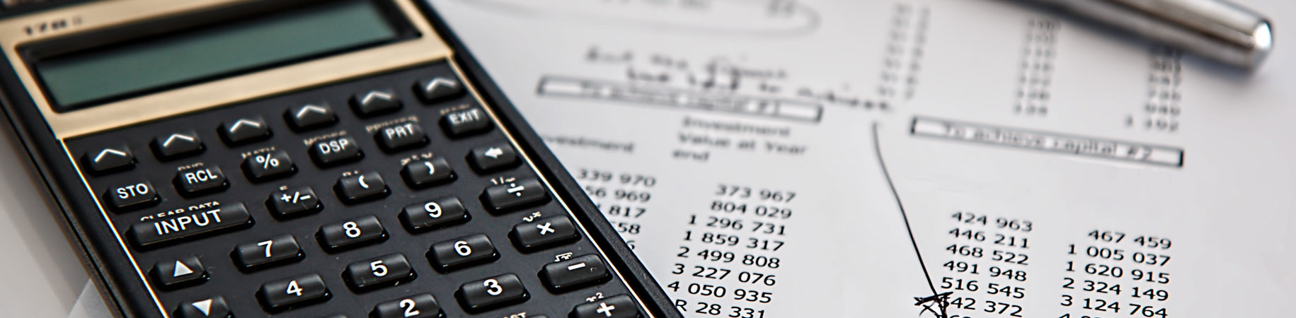 A calculator on top of financial papers.