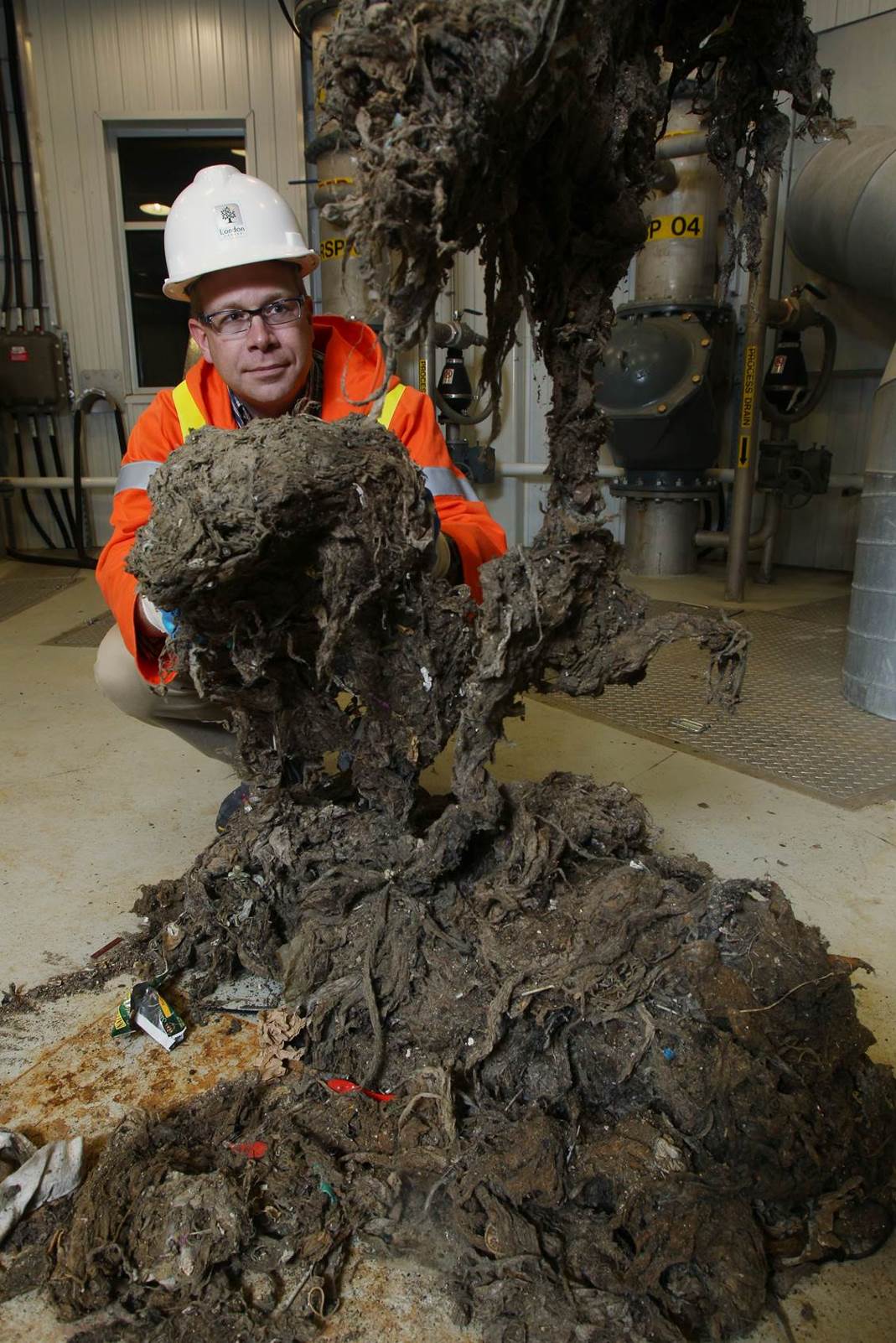Barry holding solid waste extracted from toilet flushing lines