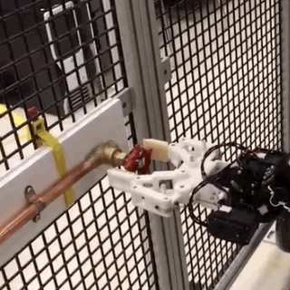 Animated gif of a robotic arm clamping down on a door knob and turning it to the left. 